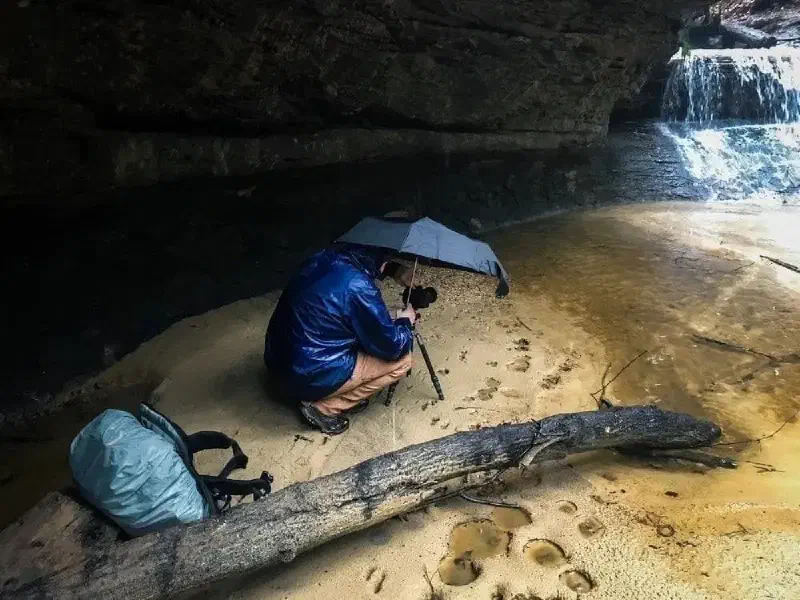 My buddy Brian captured this shot of me trying to balance my umbrella while photographing Creation Falls in Red River Gorge. He may have found it amusing, but it got the job done!