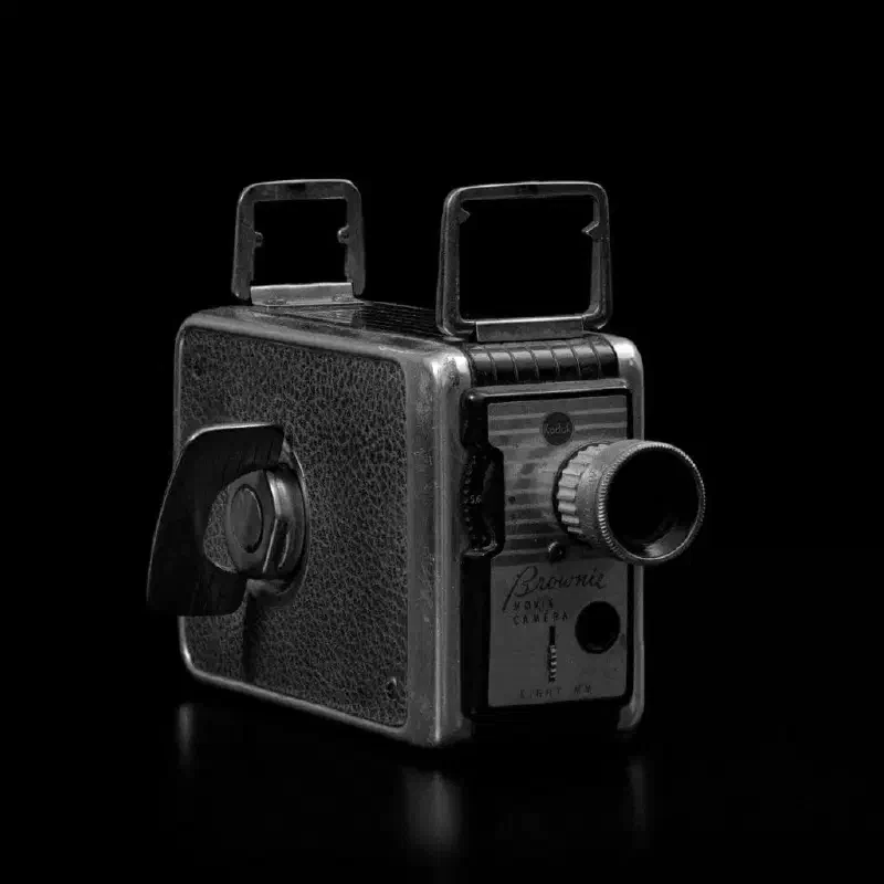 A stacked, black and white image of a vintage camera