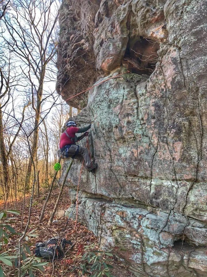 Adam Thompson ascending a rope into Leap Frog Pillar Arch 2 in the Daniel Boone National Forest.