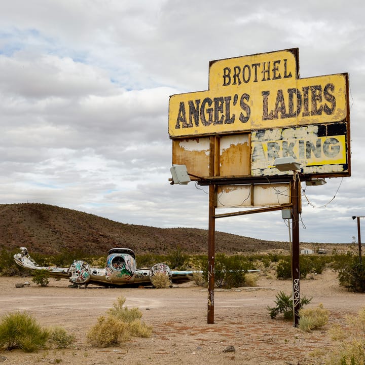 The remains of the abandoned Angel's Ladies Brothel and a wrecked plane sit in the Nevada desert.